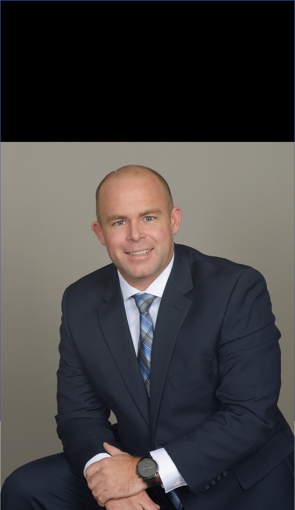 Jeff Fitzpatrick wearing a navy suit and blue tie